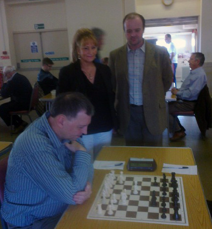 Councillors Gail Turner and Sam Wilson, standing,  check Notts Board 1, Mike Barnes' progress at the 2014 Selston county final